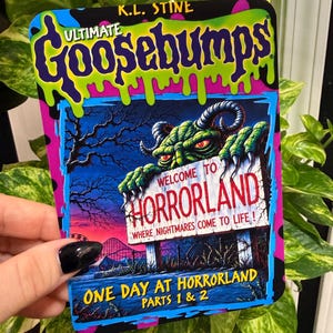 May include: A rectangular Ultimate Goosebumps sign featuring a green monster with horns peering over a sign that reads Welcome to Horrorland Where Nightmares Come to Life. The bottom text reads One Day at Horrorland Parts 1 & 2 in yellow.