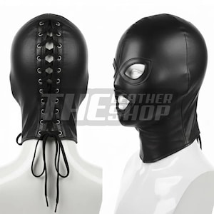 May include: Two black leather hoods. One is viewed from the back, with a lace-up closure. The other is viewed from the side, with eye and mouth openings. The text "THE LEATHER SHOP" is visible.
