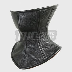 May include: A black leather neck corset with a textured surface. The corset has a curved design and is lined with a contrasting material. The edges are neatly finished with a smooth trim.