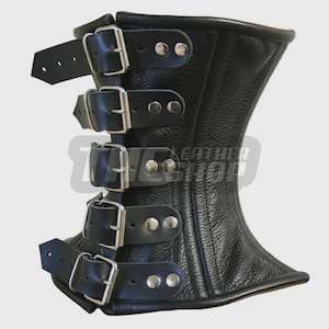 May include: Black leather corset with four rows of buckles and straps. The corset has a textured surface and a curved shape, with a wider top and bottom. Silver-colored rivets secure the straps.