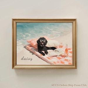 May include: A framed painting depicts a black dog wearing sunglasses, lounging on a beach towel with a book, wine, and a bottle. The word "daisy" is written on the towel. The background shows the ocean and sand.