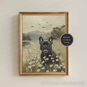 May include: A framed wall art print featuring a black French Bulldog sitting in a field of white daisies with a mountain landscape and birds in the background. A circular badge on the right side contains the text NON-TOXIC INK in gold lettering.