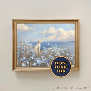 May include: A framed landscape print featuring a light-colored dog sitting in a field of pale blue flowers overlooking a calm sea with sailboats under a cloudy sky. A circular badge in the corner displays the text NON-TOXIC INK in gold lettering.