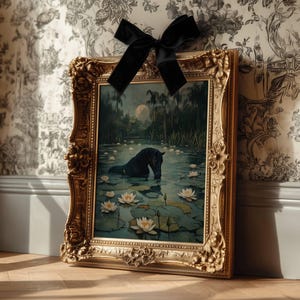 May include: A framed painting with a gold ornate frame. The artwork depicts a black horse in a pond with lily pads and white flowers. A black velvet bow is attached to the top of the frame. The background features a full moon and lush greenery.
