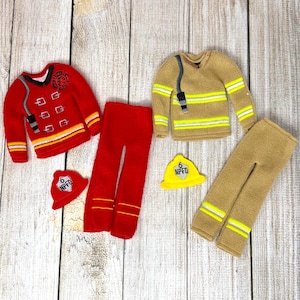 May include: Two miniature firefighter outfits, one red and one tan, with matching pants and hats. The red outfit has a jacket with a black collar and silver accents. The tan outfit has yellow stripes.