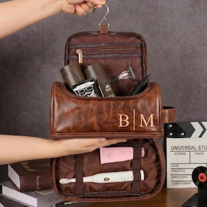 May include: A set of three ceramic mugs with a speckled, matte finish. The mugs are in shades of cream, light gray, and dark gray. Each mug has a simple, minimalist design and a rounded handle.