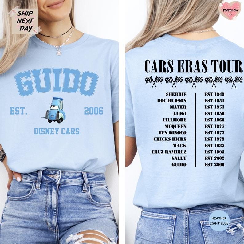 a woman wearing a light blue t-shirt with a graphic of a blue car and text related to a Cars Eras Tour.
