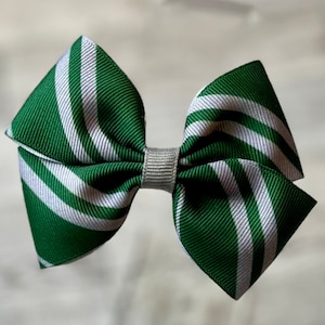 May include: Green and white striped hair bow with a silver center.