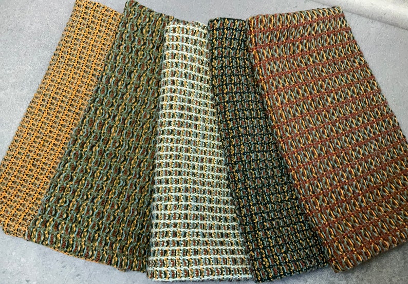 May include: Five fabric swatches with different geometric patterns in shades of brown, green, yellow, and black.