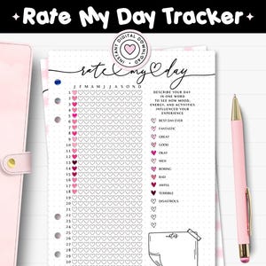 May include: A printable A4 journal page titled "Rate My Day Tracker" with a pink pen. The page features a calendar layout with heart-shaped boxes for each day of the month, and a section to describe the day in one word.