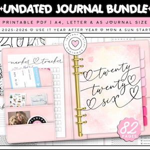 May include: A light pink ring-bound planner featuring a watercolor cover with the text twenty twenty six and heart accents. The interior includes pockets holding a marker tracker, a boarding pass, stickers, and a photo. Includes 82 pages.