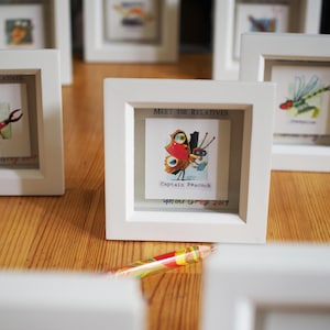 Puede incluir: Imagen enmarcada en blanco con una ilustración de mariposa colorida y el texto "Meet the Relatives, Captain Peacock,  Aunt Grey 2017".