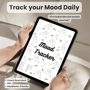 Könnte beinhalten: Ein digitaler Stimmungstracker auf einem Tablet, mit einem Kirsch- und Blättermuster. Der Text "Track your Mood Daily" und "Mood Tracker" sind sichtbar. Das Tablet zeigt auch "Printable Mental Health Journal", "Instant Download", "PDF" und "GoodNotes friendly".