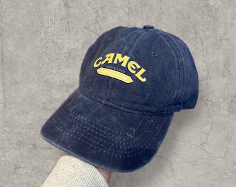 Vintage style baseball cap in navy blue with yellow camel logo.