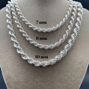 May include: Three silver rope chains of different thicknesses, 7mm, 8mm, and 10mm, displayed on a mannequin.