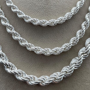 May include: Three silver rope chains of different lengths and thicknesses.