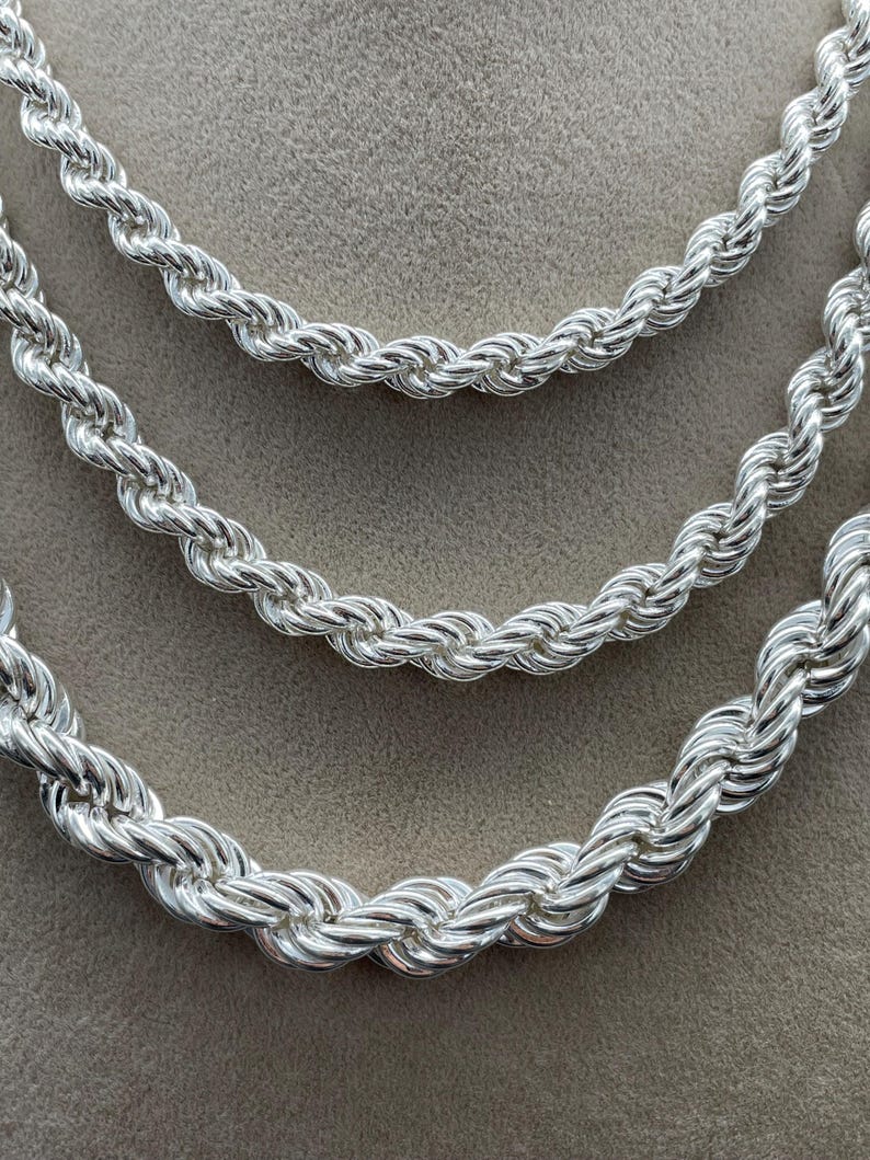 May include: Three silver rope chains of different lengths and thicknesses.