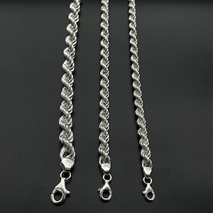 May include: Three silver rope chains of varying lengths. The chains are made of a twisted rope design and have a lobster claw clasp.