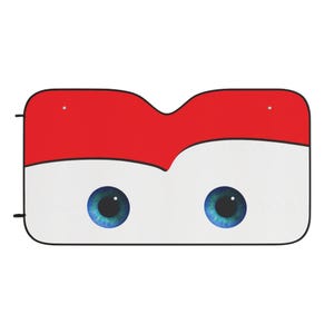 Op de afbeelding: Auto zonnescherm met een cartoon gezicht ontwerp. Het zonnescherm heeft een rood bovenste gedeelte, een wit onderste gedeelte en twee grote blauwe ogen. Het ontwerp is bedoeld om op een vriendelijk karakter te lijken.