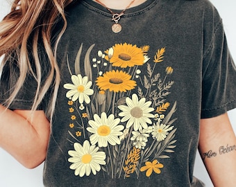 May include: A dark grey t-shirt with a floral print featuring yellow sunflowers and white daisies. The shirt has a relaxed fit and a crew neck.