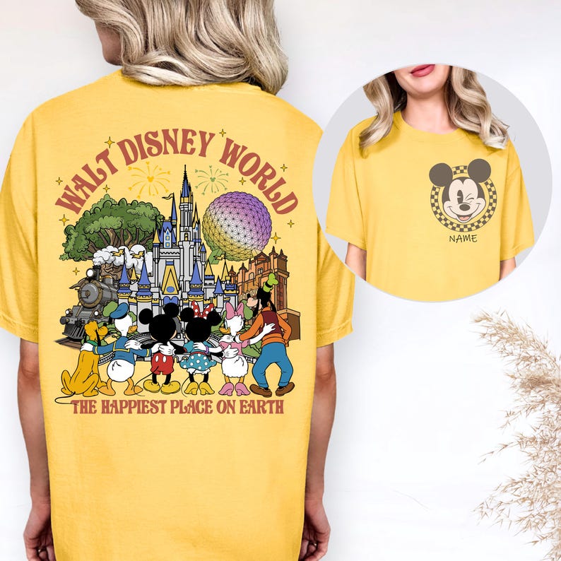 May include: Yellow t-shirt featuring a graphic of Disney characters and the text "WALT DISNEY WORLD" and "THE HAPPIEST PLACE ON EARTH". The design includes Mickey Mouse, Minnie Mouse, Donald Duck, Daisy Duck, Goofy, and a train.