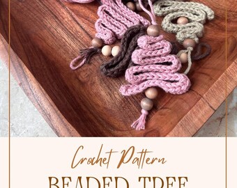 May include: Crochet pattern for a beaded tree ornament. The pattern includes instructions for making a pink, brown, and green beaded tree ornament. The image shows the finished ornament and the yarn used to make it.  https://pkcreationscrochet.etsy.com