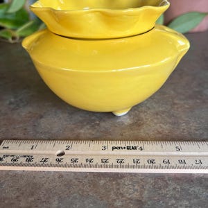 May include: A white ceramic mug with a black handle and the text "But First, Coffee" in a black, bold font. The mug is sitting on a white surface.