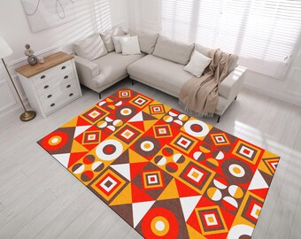 May include: A geometric patterned rug with red, orange, white, brown, and yellow squares, circles, and triangles. The rug is on a light wood floor in a living room setting.