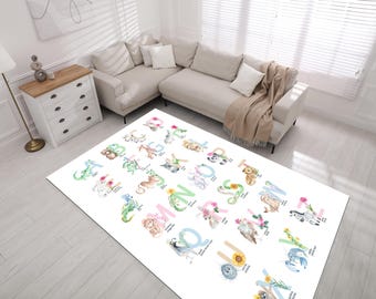 May include: A white alphabet rug with colorful letters and illustrations of animals. Each letter is paired with an animal and a word, such as "A is for Apple".
