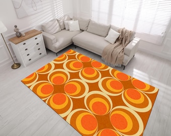May include: A brown, orange, and white patterned rug with a retro design. The rug features a repeating pattern of concentric circles.