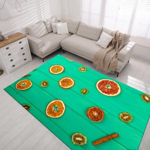 May include: A rectangular area rug featuring a vibrant turquoise background with a printed pattern of dried orange slices, kiwi slices, and cinnamon sticks arranged across a design that mimics the appearance of horizontal wooden planks.