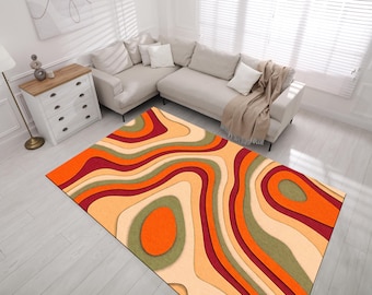 Op de afbeelding: Abstract vloerkleed met een golvend, gelaagd ontwerp in tinten oranje, rood, beige en groen.