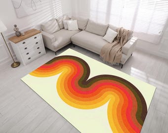 May include: A white rug with a colorful, abstract design of wavy, multi-colored stripes in shades of orange, yellow, red, brown, and green.
