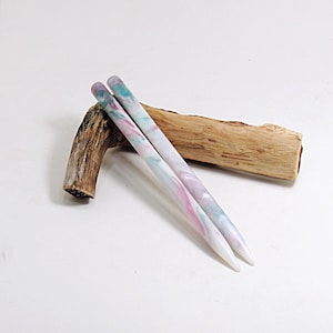 May include: A white ceramic mug with a black handle and the text "But First, Coffee" in a black, bold font. The mug is on a white surface.