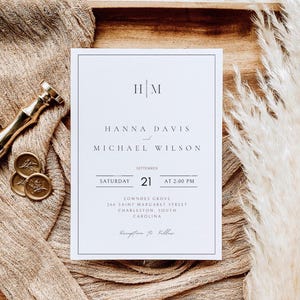 May include: A white wedding invitation with black text. The invitation reads "HM, Hanna Davis and Michael Wilson, September 21 at 2:00 PM, Lowndes Grove, 266 Saint Margaret Street, Charleston, South Carolina, Reception to Follow."