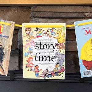 May include: A yellow banner with a variety of Little Golden Books featuring popular characters like Mickey Mouse, Big Bird, and the Little Golden Books logo. The banner reads "Story Time".