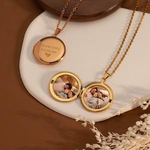 May include: Gold locket necklace with a photo of a family inside and an inscription on the other side that reads "I love you forever".