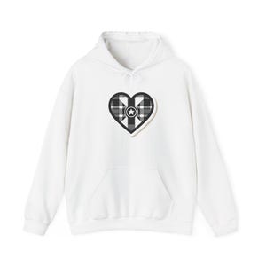 May include: White hooded sweatshirt with a black and white plaid heart design featuring a star in the center.