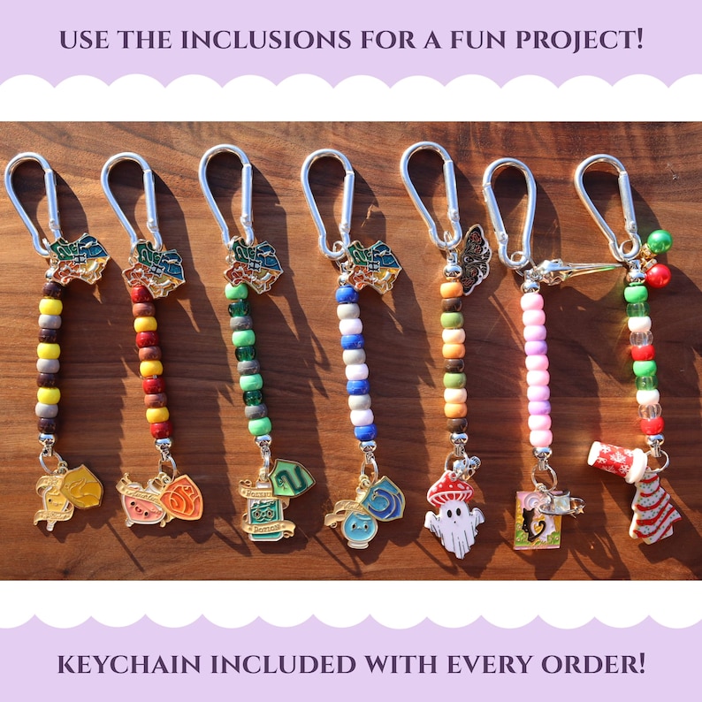 May include: A collection of keychains with colorful beaded strands and decorative charms. Each keychain features a different charm, including a mushroom, a ghost, and a gift box. The text "USE THE INCLUSIONS FOR A FUN PROJECT!" is at the top.