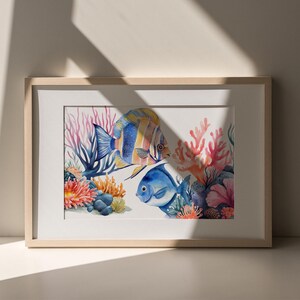May include: A framed watercolor painting of two colorful fish swimming among coral reefs. The fish are blue, yellow, and orange, and the coral is pink and red.