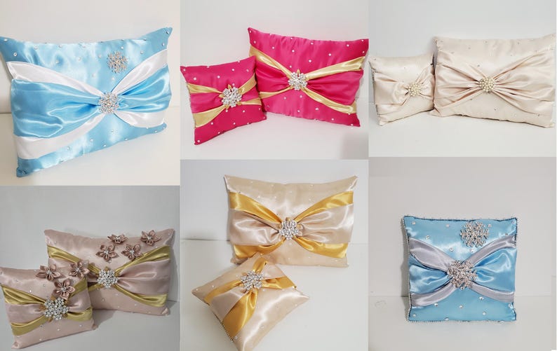 May include: Assortment of decorative throw pillows with satin fabric and jeweled embellishments. The pillows are in various colors, including blue, pink, gold, and beige.
