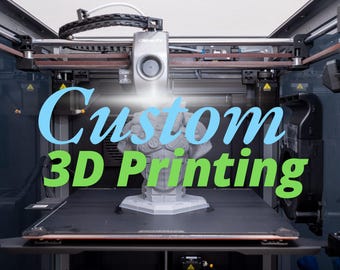 May include: A 3D printer with a gray plastic bust being printed. The printer has a black and silver frame and a brown belt. The text "Custom 3D Printing" is displayed on the front of the printer.