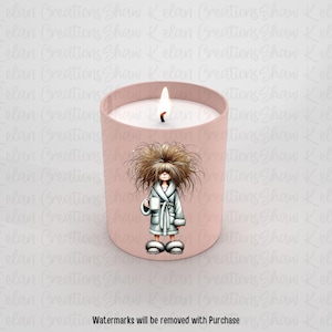 May include: A pink candle with a white wax top and a cartoon illustration of a woman with messy hair wearing a robe and holding a mug. The candle is on a white background.