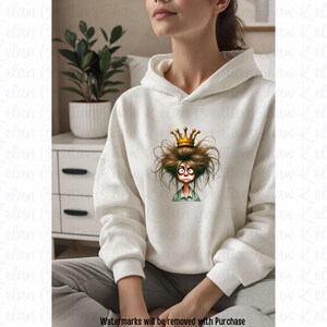 May include: A white hoodie with a graphic of a cartoon character wearing a crown. The character has messy brown hair and a surprised expression.
