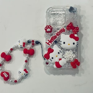 Red Black & White Hello Kitty IPhone Android Trendy Custom Clear Junk Cell Phone Case Custom for Baddies iPhone 16 Pro with matching Hello Kitty Anti Lost Phone Bracelet. Red Black & White Hello Kitty IPhone Android Cell Phone Case Custom for Baddies