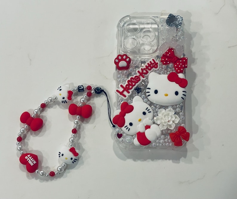Red Black & White Hello Kitty IPhone Android Trendy Custom Clear Junk Cell Phone Case Custom for Baddies iPhone 16 Pro with matching Hello Kitty Anti Lost Phone Bracelet. Red Black & White Hello Kitty IPhone Android Cell Phone Case Custom for Baddies