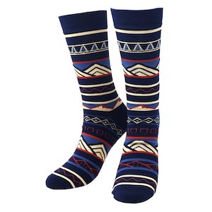 May include: A pair of navy blue socks with a geometric pattern. The design includes white, red, and blue horizontal stripes, triangles, and diamond shapes. The socks are knee-high and have a ribbed cuff.
