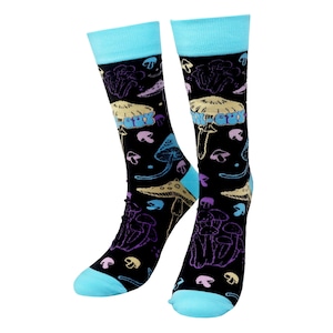 May include: A pair of black crew socks with a colorful mushroom pattern. The socks feature a light blue cuff, heel, and toe. The mushroom designs are in shades of purple, yellow, and blue.