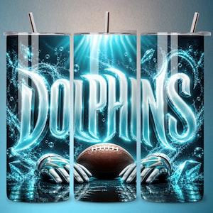 May include: A cylindrical tumbler featuring a vibrant graphic design with the word DOLPHINS in glowing light blue letters. The background displays splashing water, bubbles, a brown football, and a pair of athletic gloves in a dark, aquatic theme.