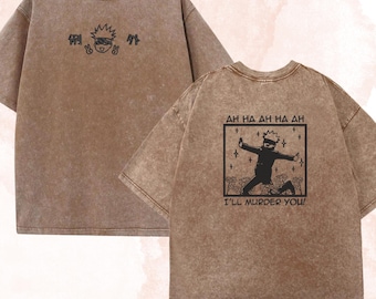 May include: A brown acid-wash t-shirt featuring a front graphic of a cartoon character with Japanese text and a back graphic of a character in a box with the text AH HA AH HA AH I'LL MURDER YOU! and star accents. The brand name KaydenC is visible.